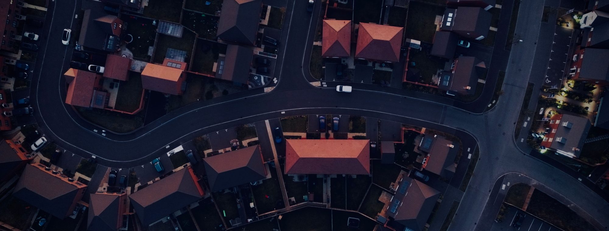 An aerial view of a suburban housing estate at dusk